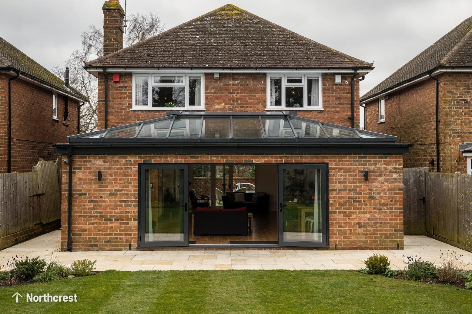 Brick house with a single-storey rear extension topped by a long roof lantern above sliding doors